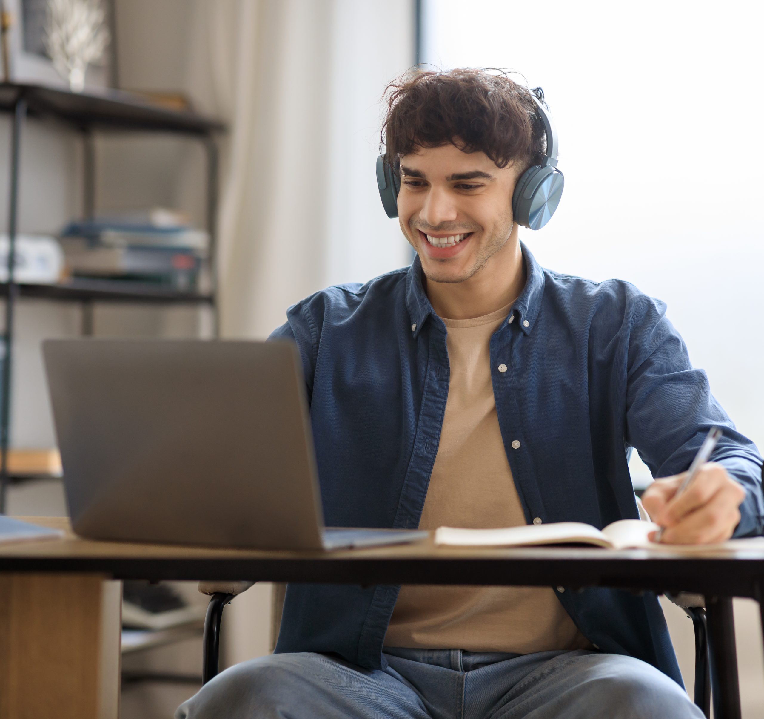 Happy Guy Using Laptop Computer Learning And Working Online Indoors